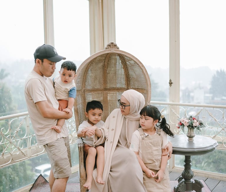 Family portrait inside glass house during a family photography session at Rumah Gemuk Bedugul Bali.