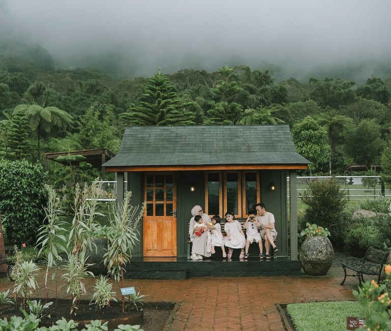Family walking in rain during a family photography session at Rumah Gemuk Bedugul Bali.