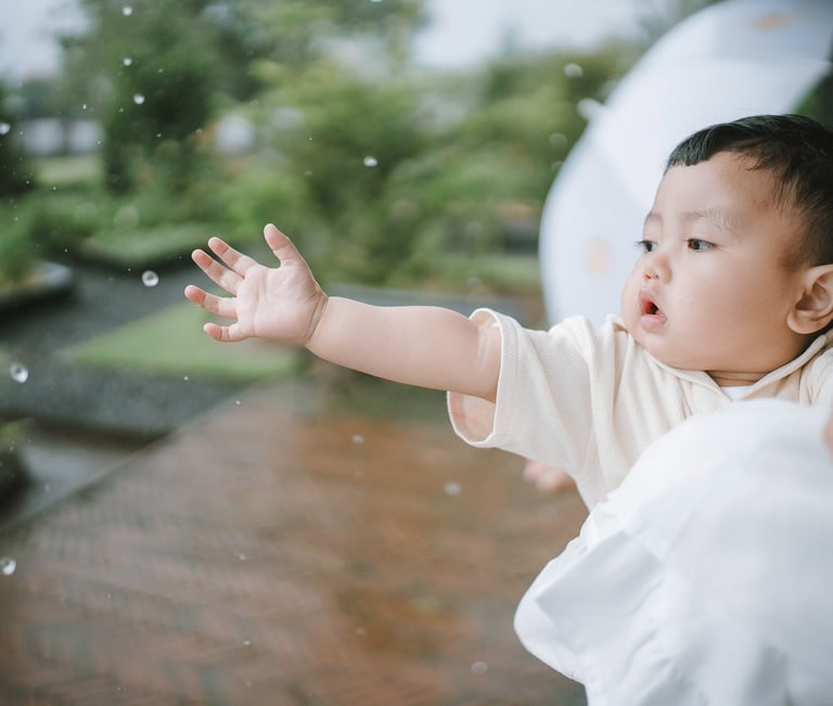 Baby reaching hands during a family photography session at Bali Farm House Bedugul Bali.