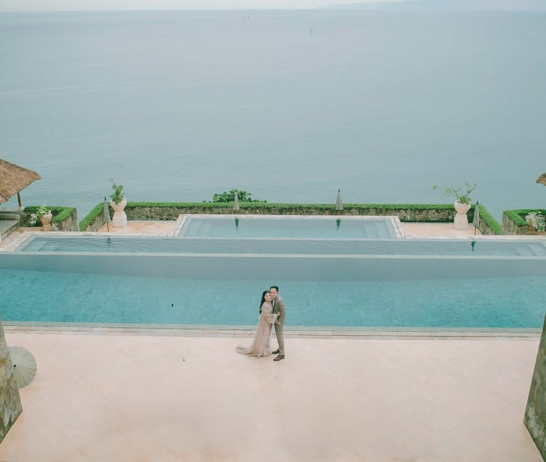 Elegant prewedding session at Amankila infinity pool overlooking the ocean in Karangasem Bali