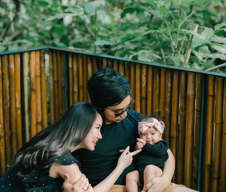 Father and baby near window during a family photography session at a private villa in Ubud Bali.