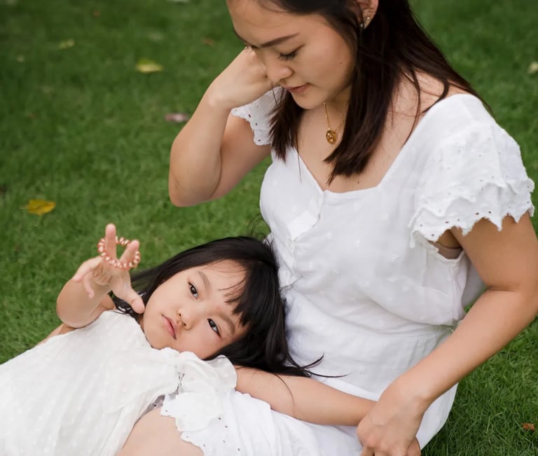 Quiet mother and child portrait on the grass at a private villa in Seminyak Bali with natural light and soft lifestyle story