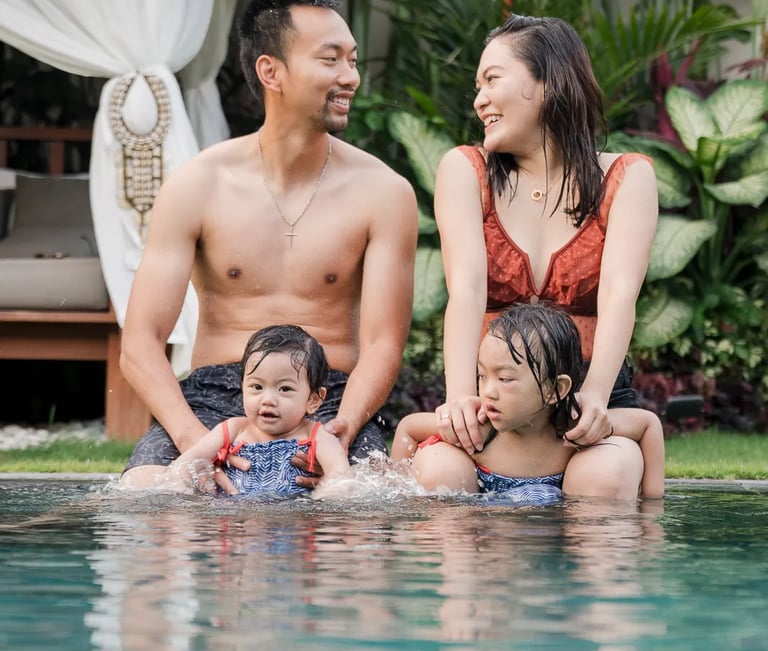Playful family photography session by the pool at a private villa in Seminyak Bali with relaxed tropical lifestyle moments.