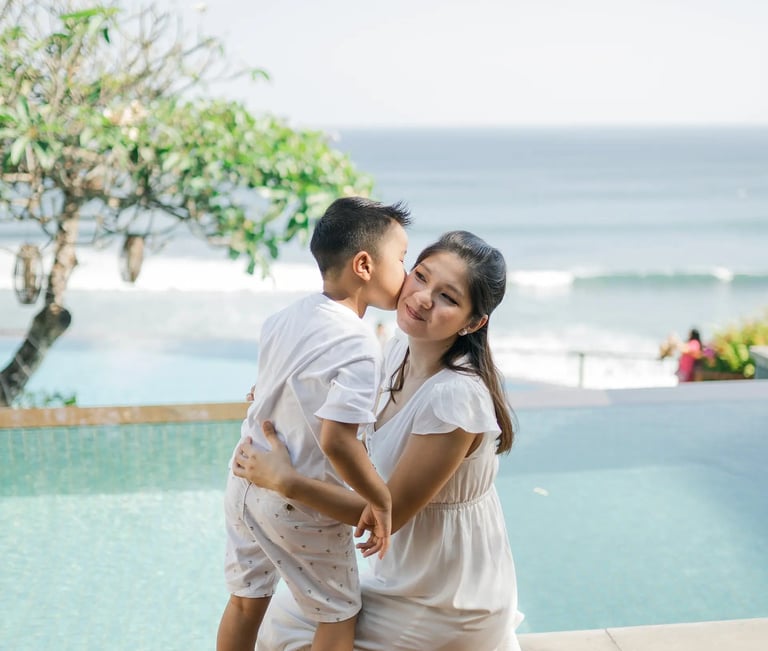 Parents sharing a quiet moment by the pool during a family session at Anantara Uluwatu.