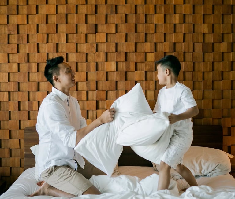 Parents sharing a quiet indoor family moment at Anantara Uluwatu Bali.