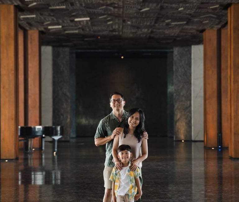 Family portrait standing inside modern resort architecture at The Meru Sanur Bali family photography