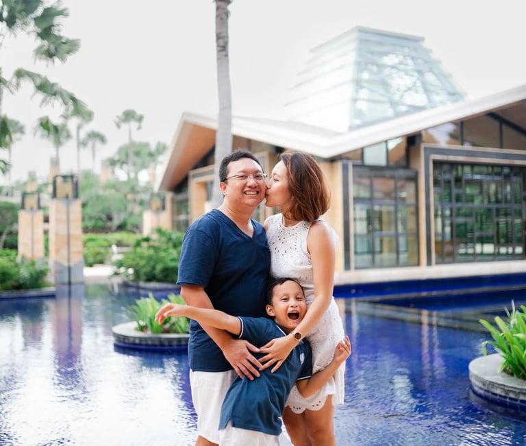 Family portrait beside reflecting pool at The Mulia Nusa Dua Bali