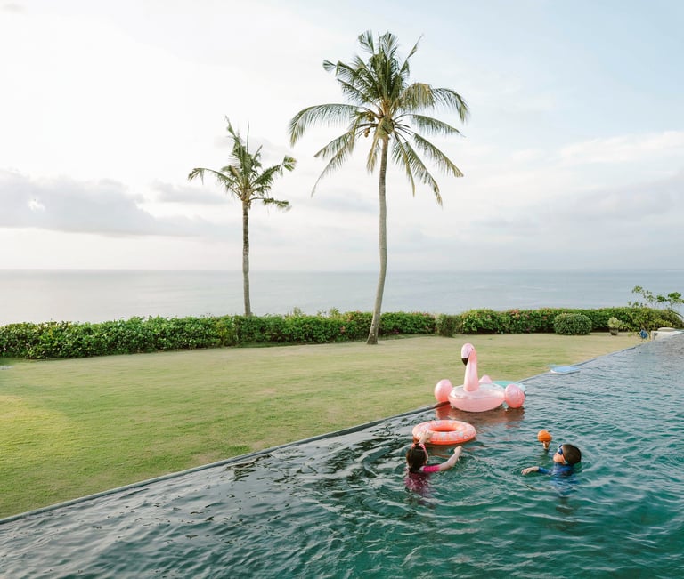 Children swimming in private infinity pool at AYANA Villas Jimbaran Bali – lifestyle family photography