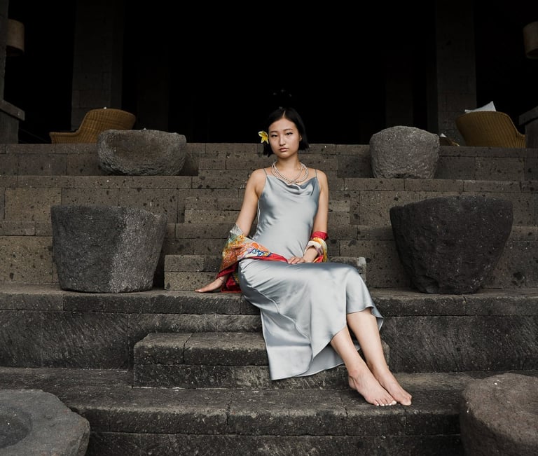 Daughter portrait seated on stone steps at Bvlgari Resort Uluwatu Bali, timeless luxury portrait photography in Bali