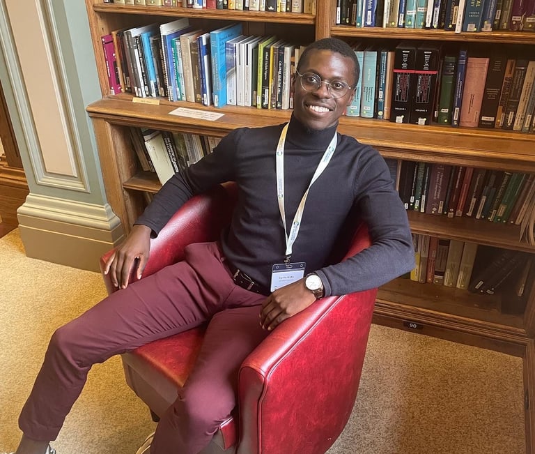 a man sitting in a chair in a library