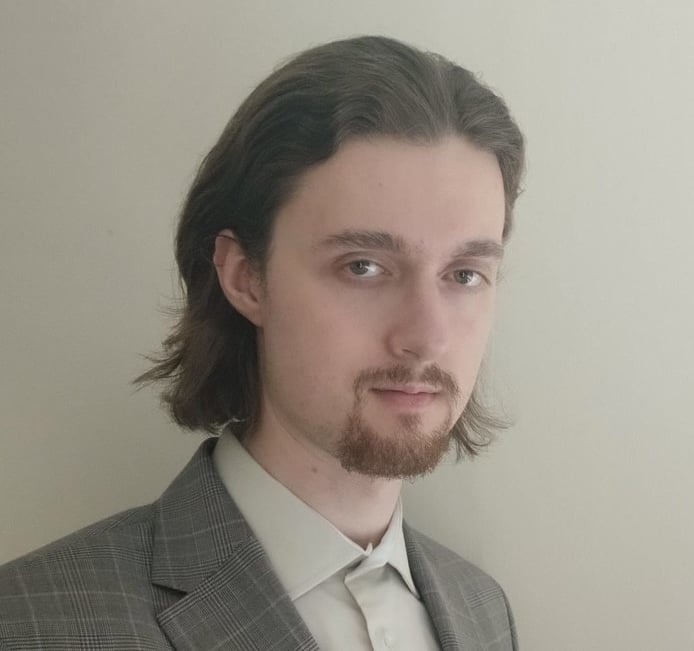 a man with a beard and a suit jacket