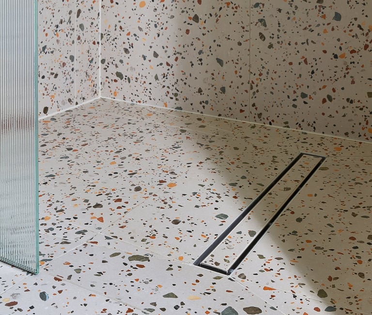 large-format terrazzo tiles in a wet room with tile in shower base