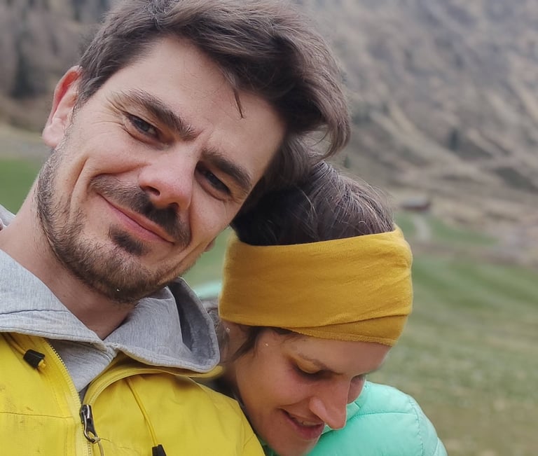 a man and woman are smiling and hugging