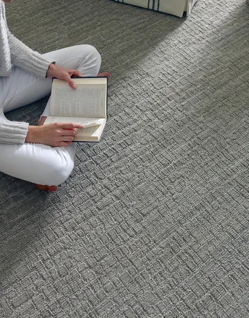 Modern textured design carpet with subtle geometric pattern in neutral tone.