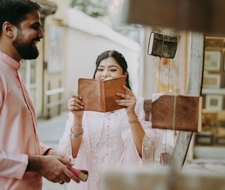 a man and woman in the streets of old city, udaipur, reading books