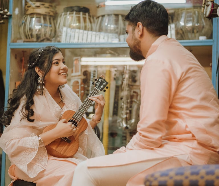 a man and woman playing guitar together