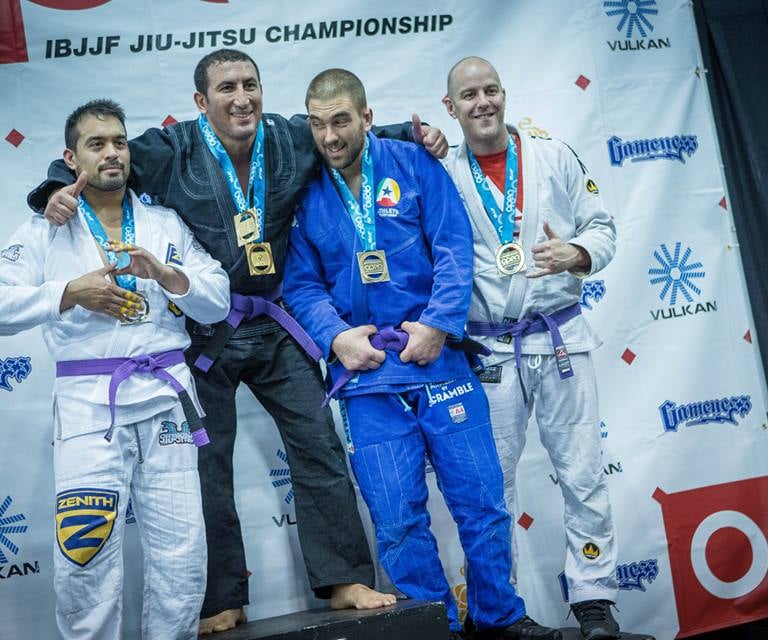 a group of people standing on a stage with medals