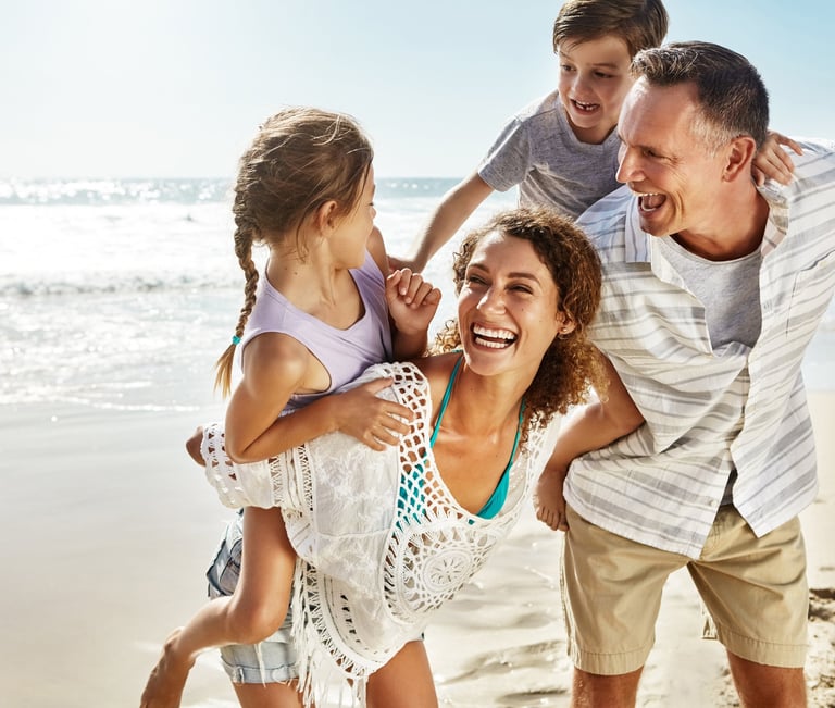 Happy family on the beach making the most of the day