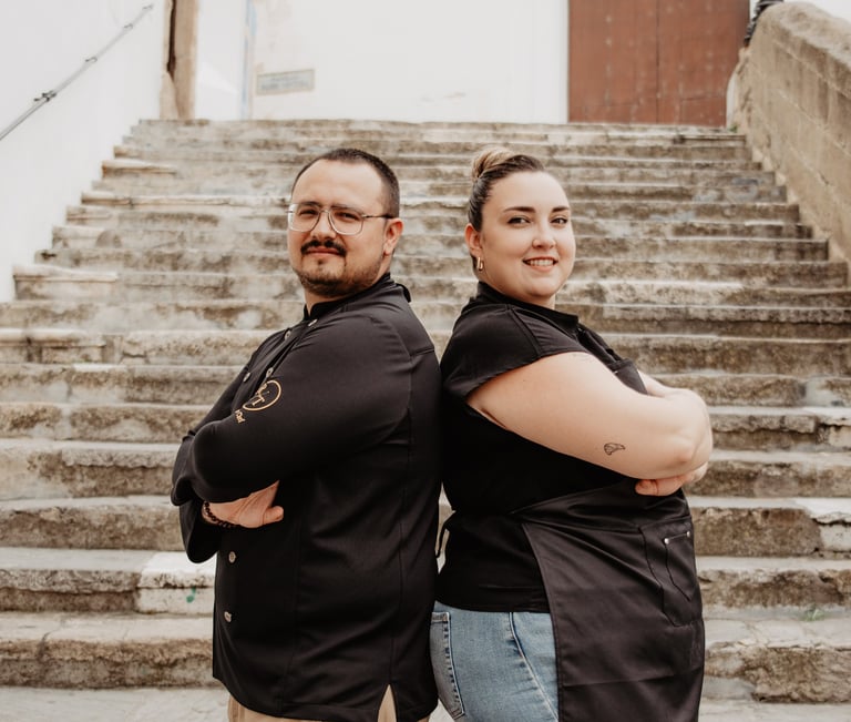 Luis and Anyi, private chefs, posing together as a culinary team