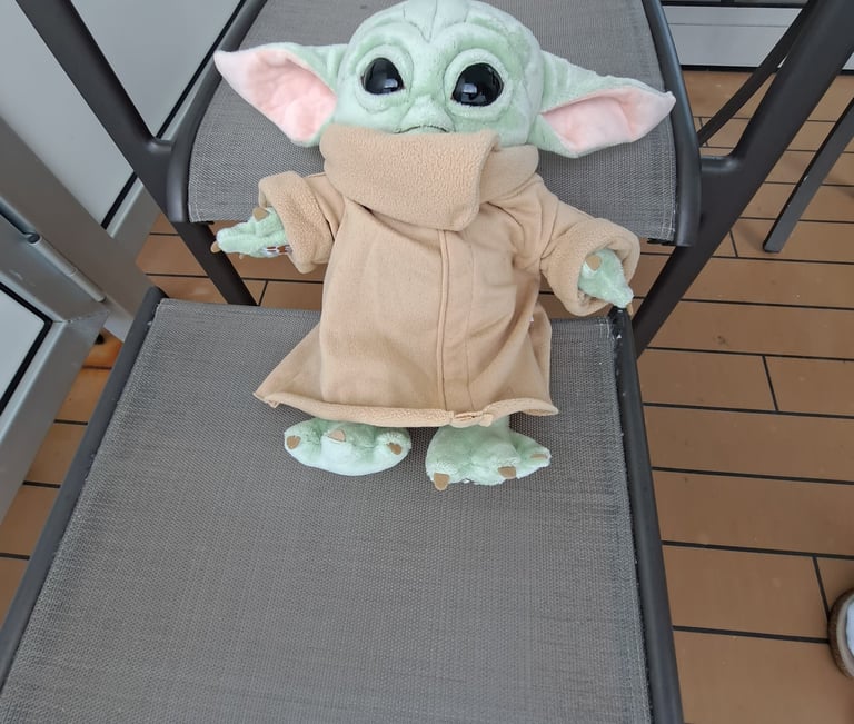 Little Green Stuffed animal on deck chair