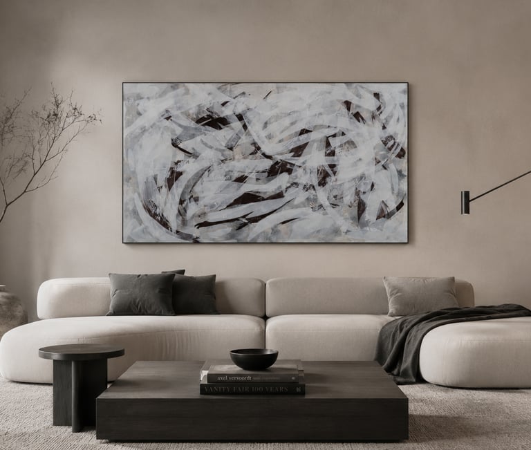 Modern minimalist living room with a white curved sofa and large abstract wall art.