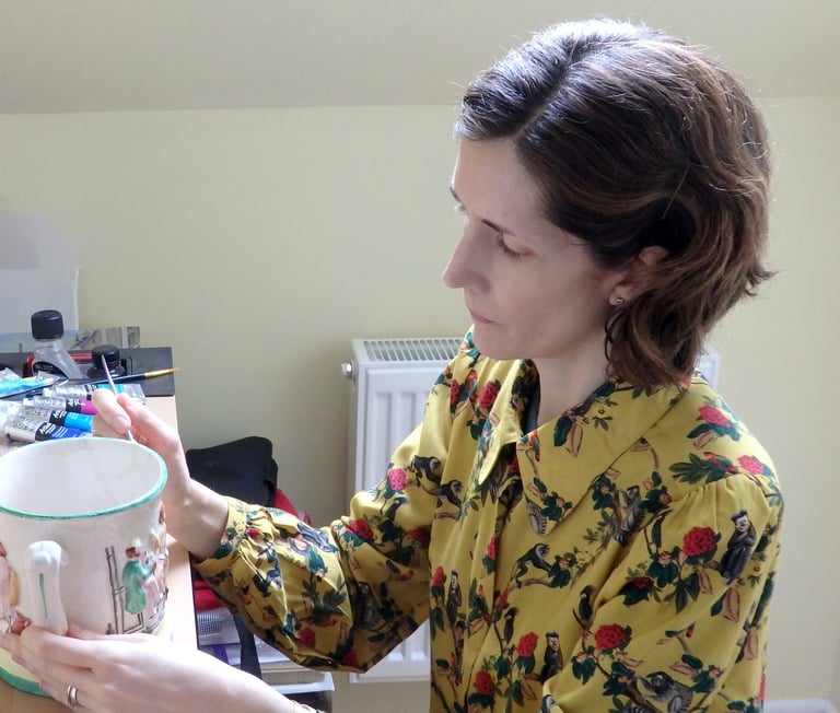 Mandy conserving a ceramic frog surprise mug