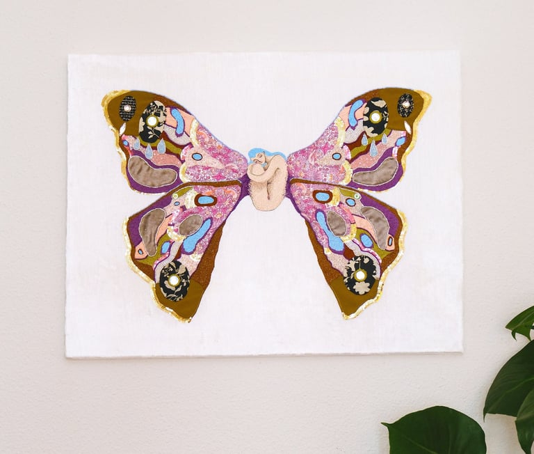 a butterfly embroidery artwork with a woman in the center