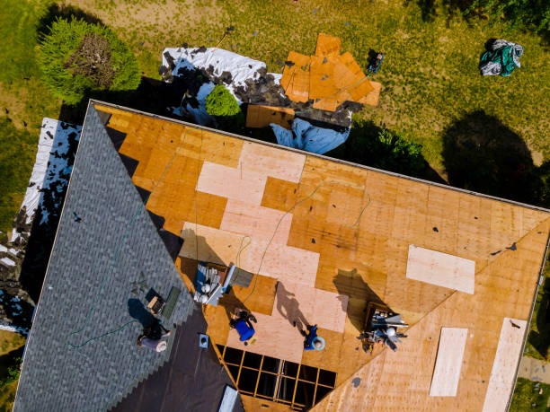 sky view of construction workers installing roof tiles