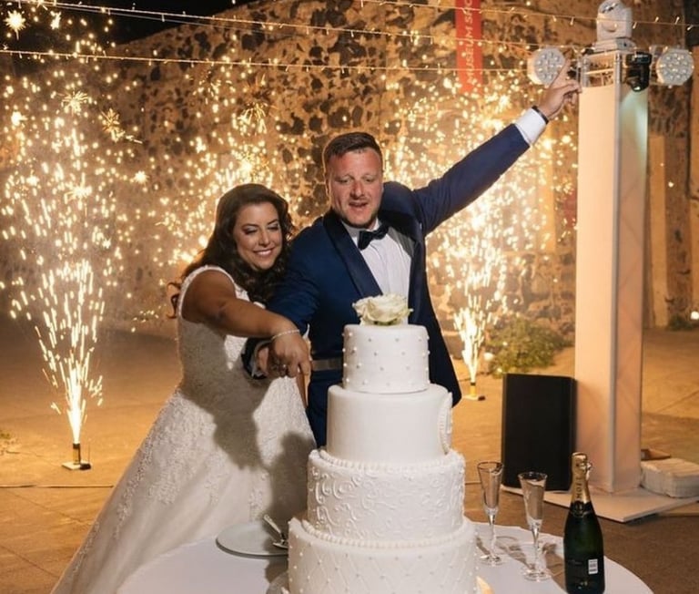 Spectacular fireworks display as the couple cuts their wedding cake in Santorini.