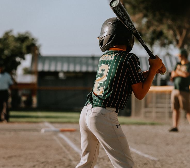 Custom baseball uniforms in moisture-wicking polyester with logos, numbers, and artwork options.