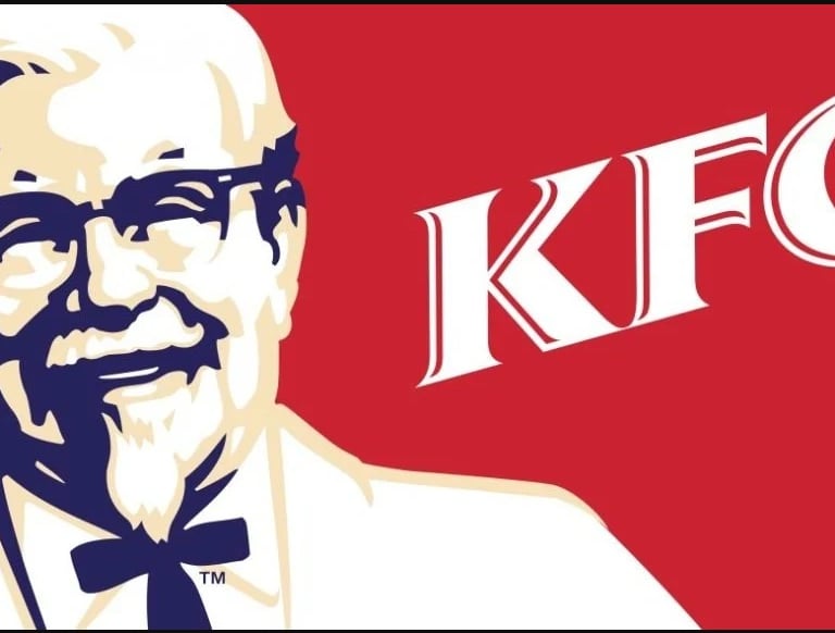 a man with glasses and a tie on a red background