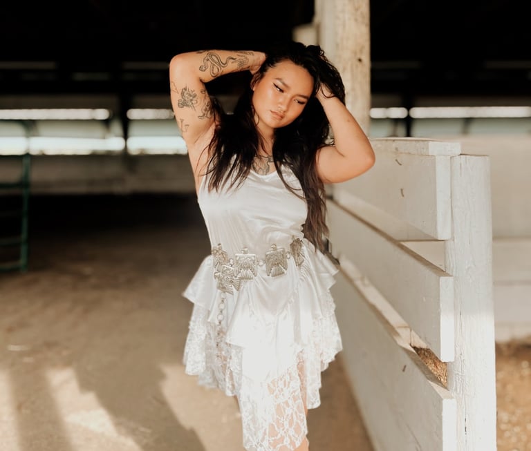 a woman in a white dress and cowboy boots