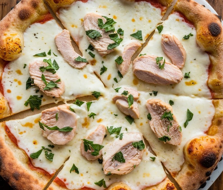 A Garlic Chicken Alfredo Pizza with a golden, crispy crust. The surface is creamy white 