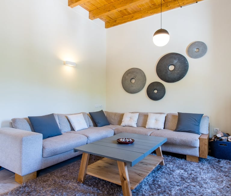 Modern and minimal country house living room with wood stove and corner sofa