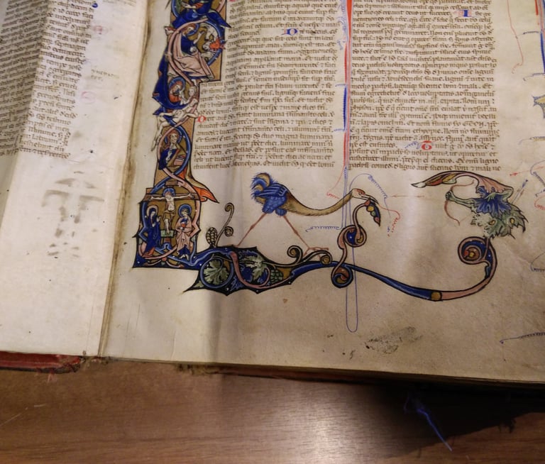 A lavishly decorated page of a bible, 13th Century, Italy.