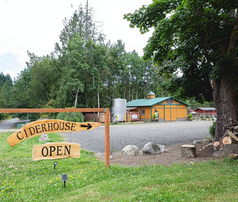 Rustic wooden ciderhouse open sign at a local hard cider orchard and cidery building.