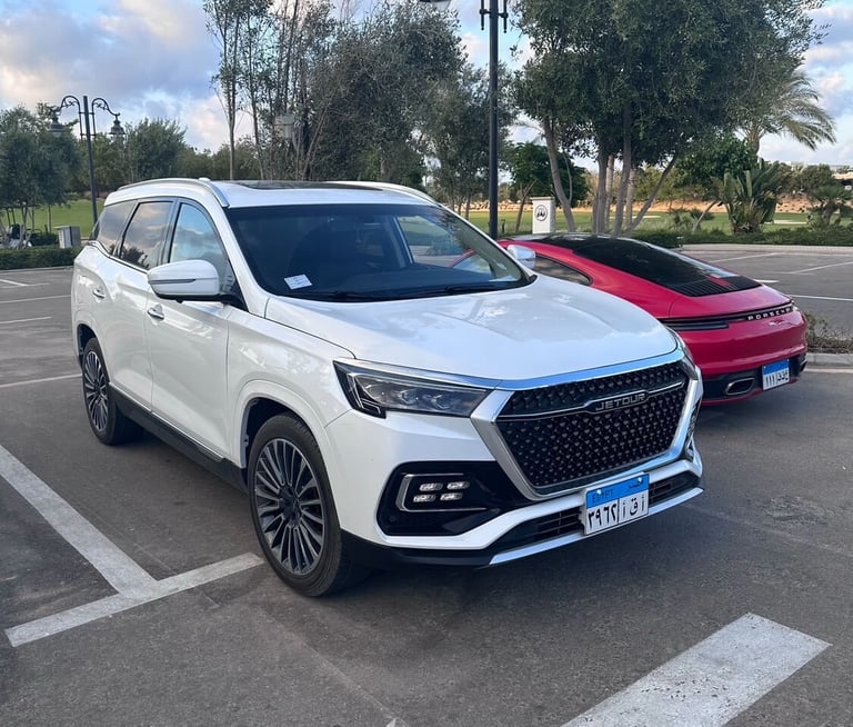 a white suv parked in a parking lot