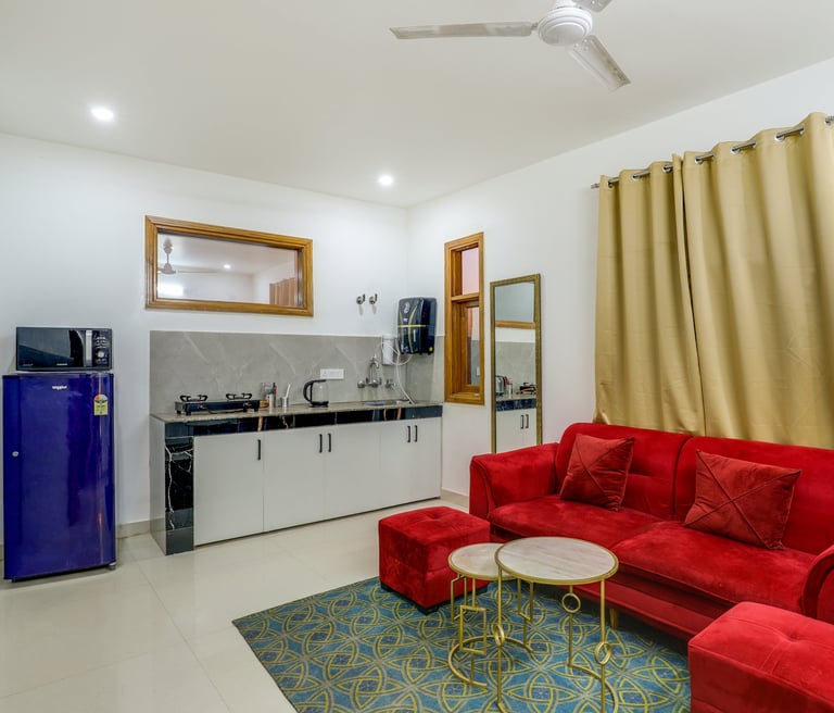 "Living room of 1 BHK apartment with sofa and TV" "Dining area inside 1 BHK apartment"