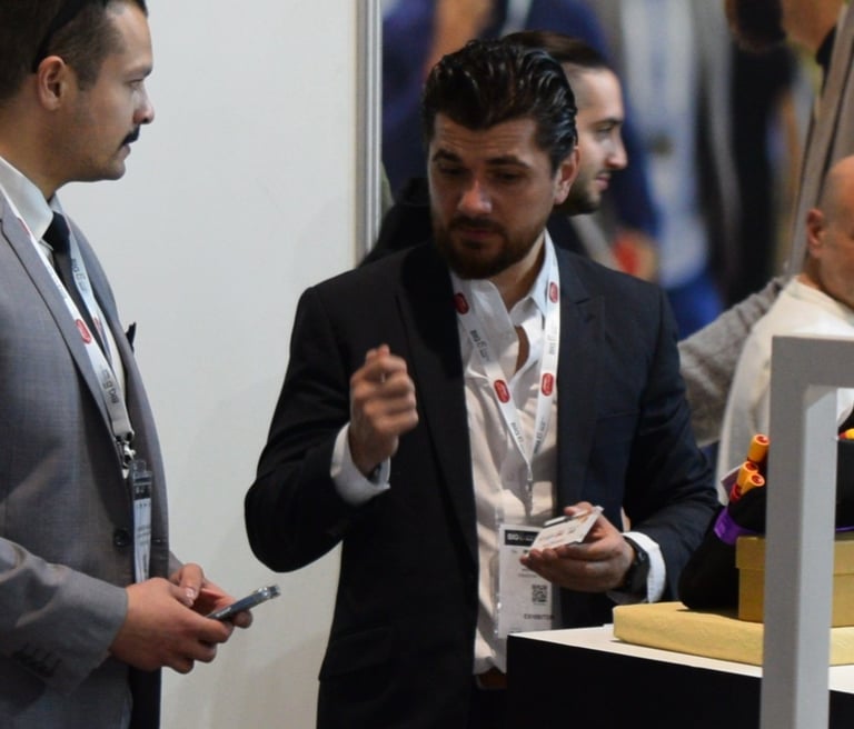 a man in a suit and tie is talking to a man in a suit