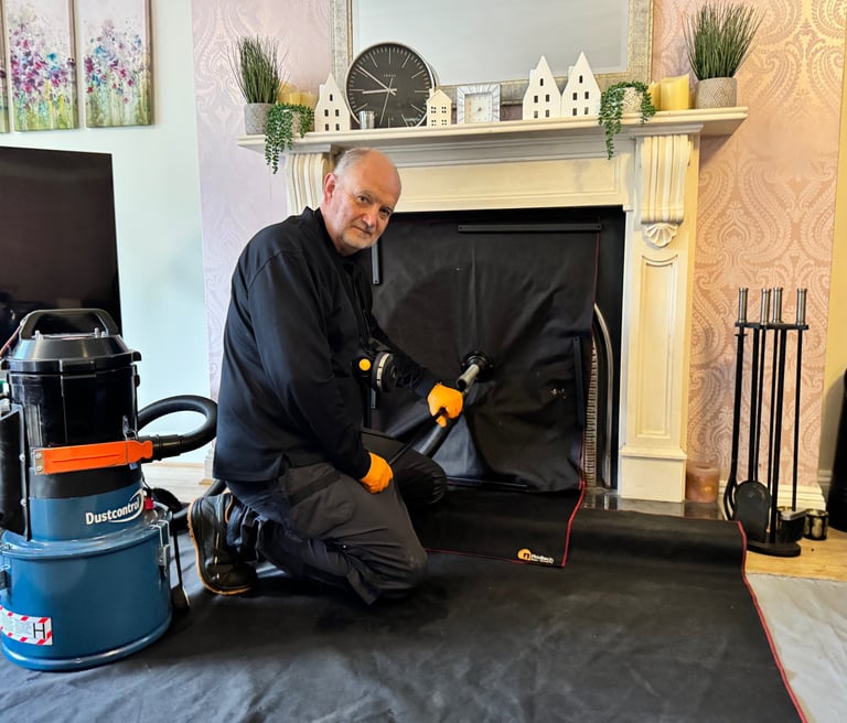 a man in a black jacket and gloves is sweeping a chimney