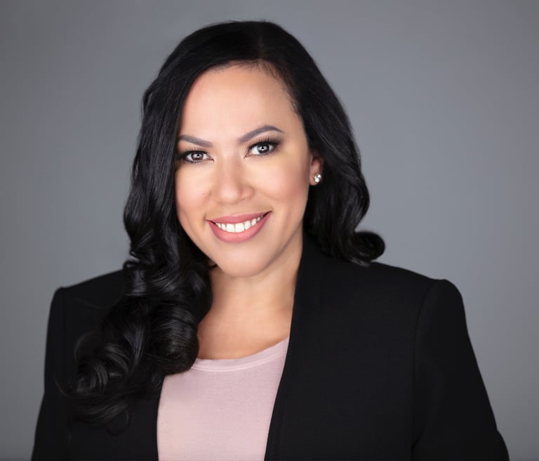 a woman in a black suit and pink top