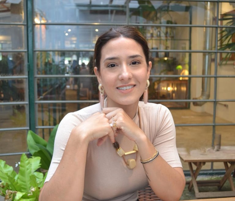 a woman sitting at a table with a laptop