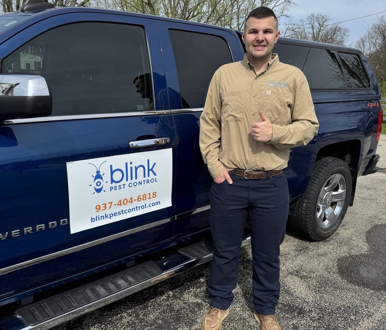 Blink Pest Control Owner standing by truck