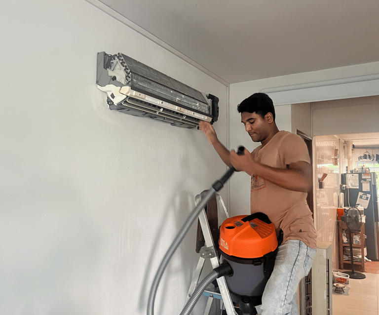 Cool Speed Engineering technician conducting routine aircon servicing and cleaning on a residential