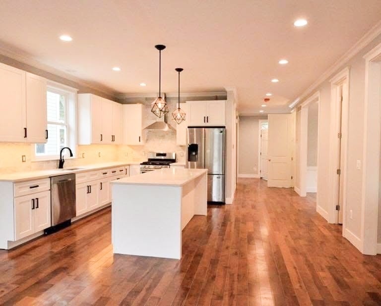 Custom upper and lower kitchen cabinets and island designed and built by Pearce Woodworks Detroit. 
