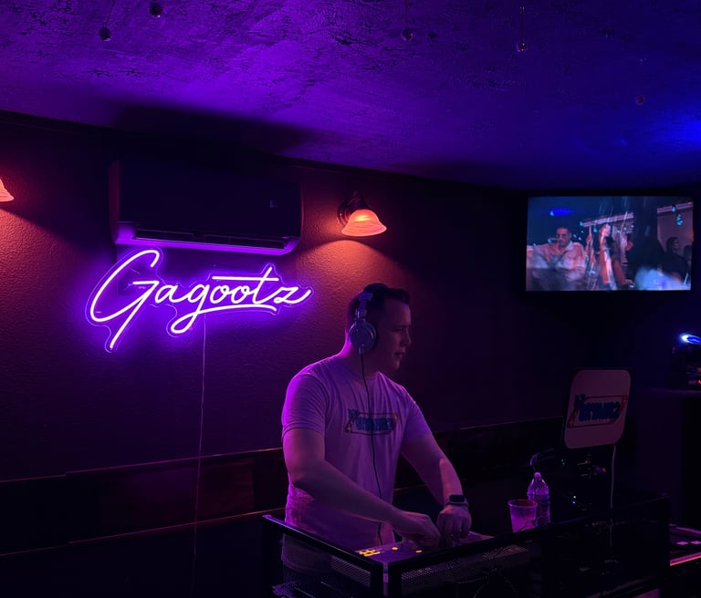 DJ BryanC2 mixing music and music videos at Gagootz bar.