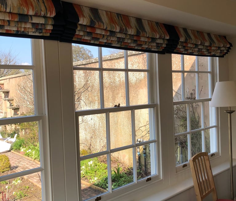 3 hand sewn blinds in an orangery with contrast borders