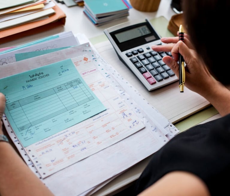 a woman is sitting at a desk with a calculator and a calcula
