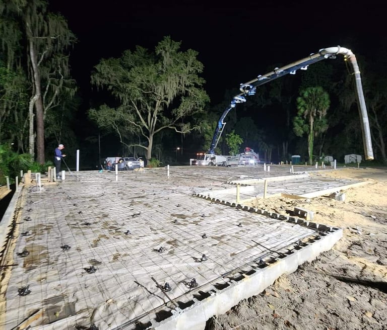 Pumping concrete on a night-time construction job with a boom pump.