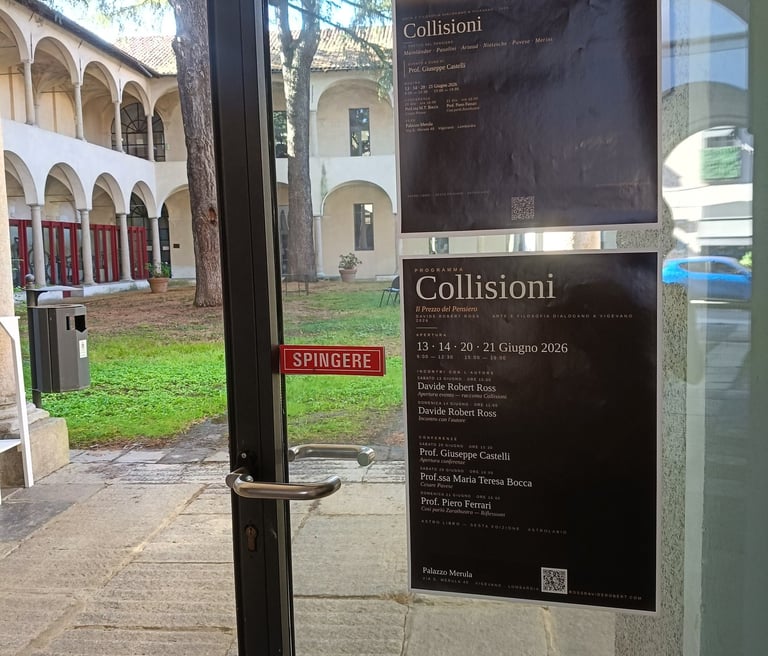 Posters for the Collisioni art exhibition by Davide Robert Ross on a glass door overlooking a courtyard.